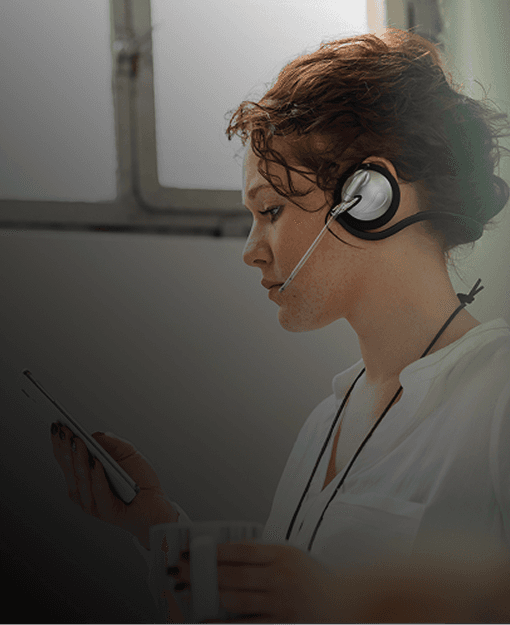 Woman with headset at her desk - Business Phone Systems